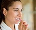 Woman brushing with stannous fluoride toothpaste