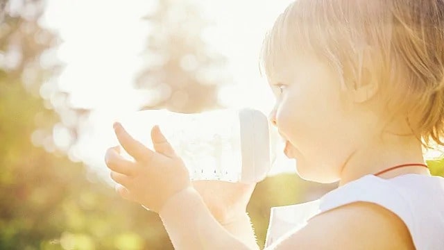 toddler drinking from a bottle