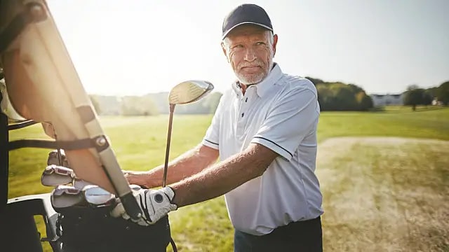 Man golfing after root canal infection treatment