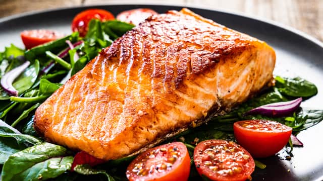 Grilled salmon on a plate with veggies