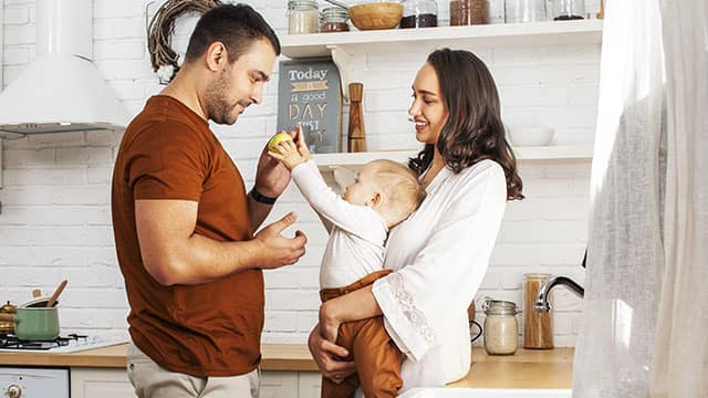 A young family with a little son in the kitchen happy smiling