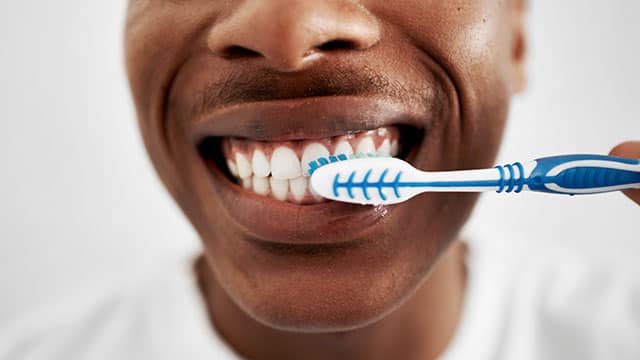 Closeup of the man brushing the teeth