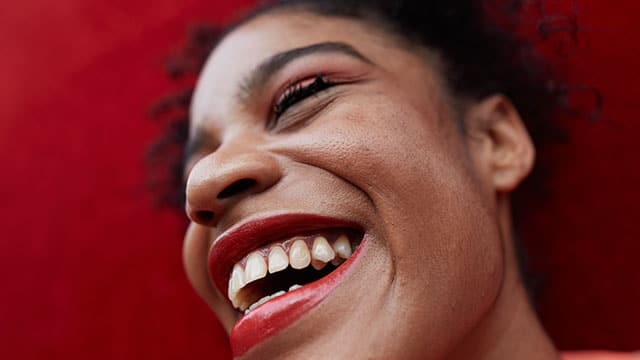 A close up of a woman's face smiling