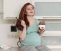 pregnant woman eating a tooth-friendly snack