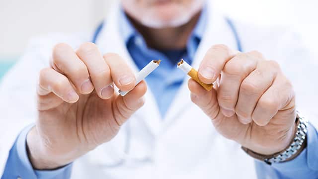close-up of doctor breaking a cigarette