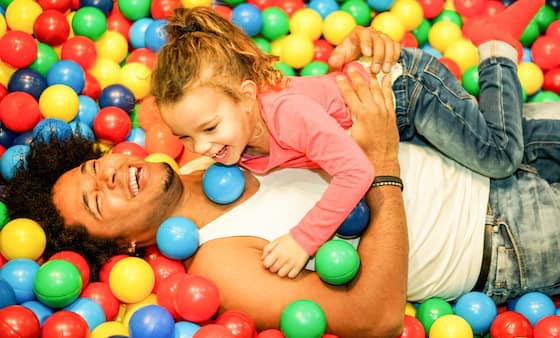 father and daughter in a ball pit