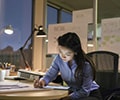 Businesswoman with digital tablet working late in an office