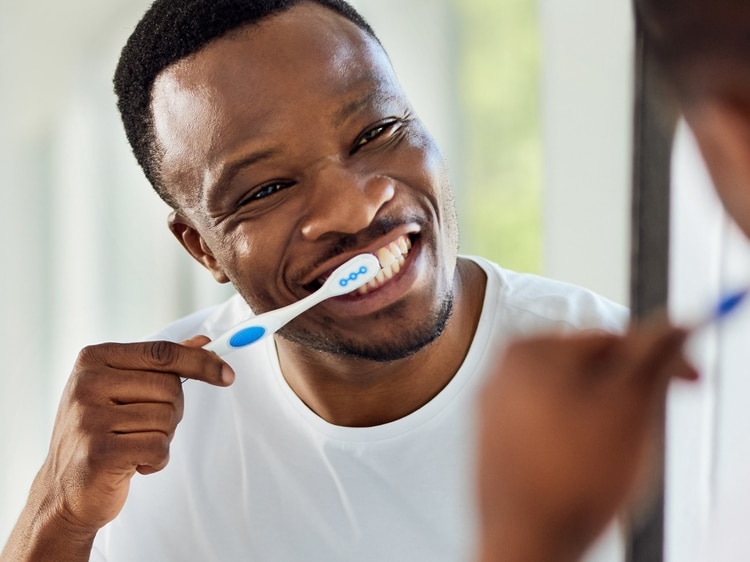 man brushing with colgate toothbrush