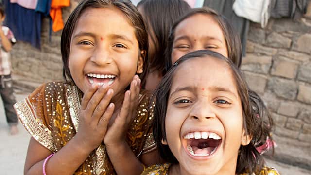Indian kids laugh with their white teeth