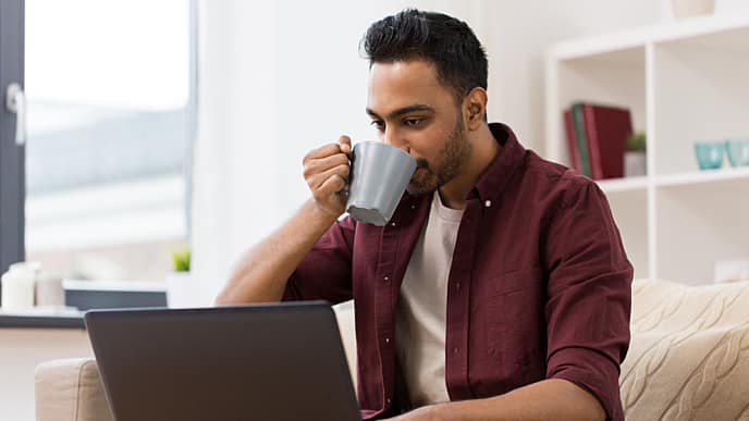 man having coffee and reading about mouth cancer