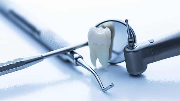 tooth next to dental equipment
