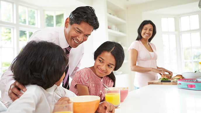 Dad teaching his children with eating habits good for teeth