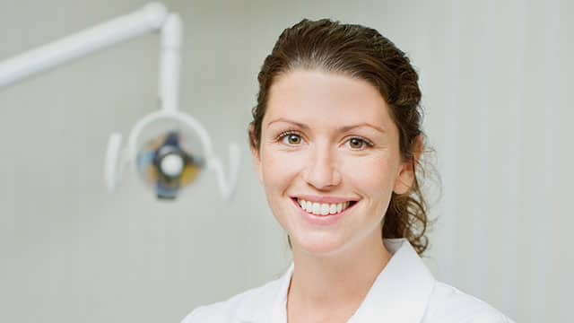 A female dental hygienist in the dental office