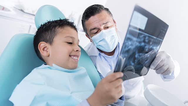 Dentist and kid in the dental office