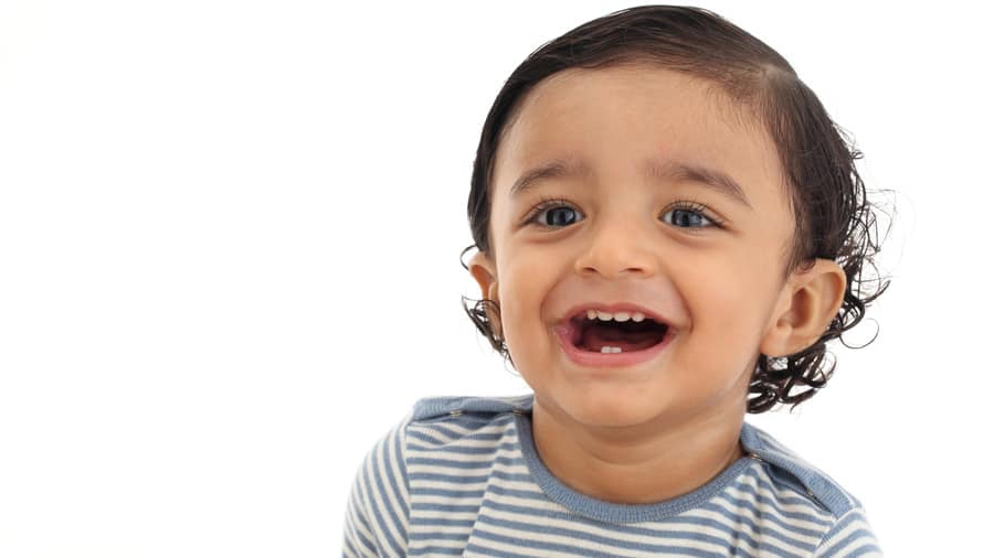 Cheerful baby boy smiling with healthy teeth