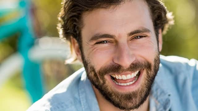 man smiling after dental bridge procedure