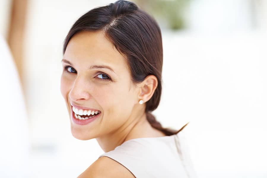 Woman smiling over her shoulder