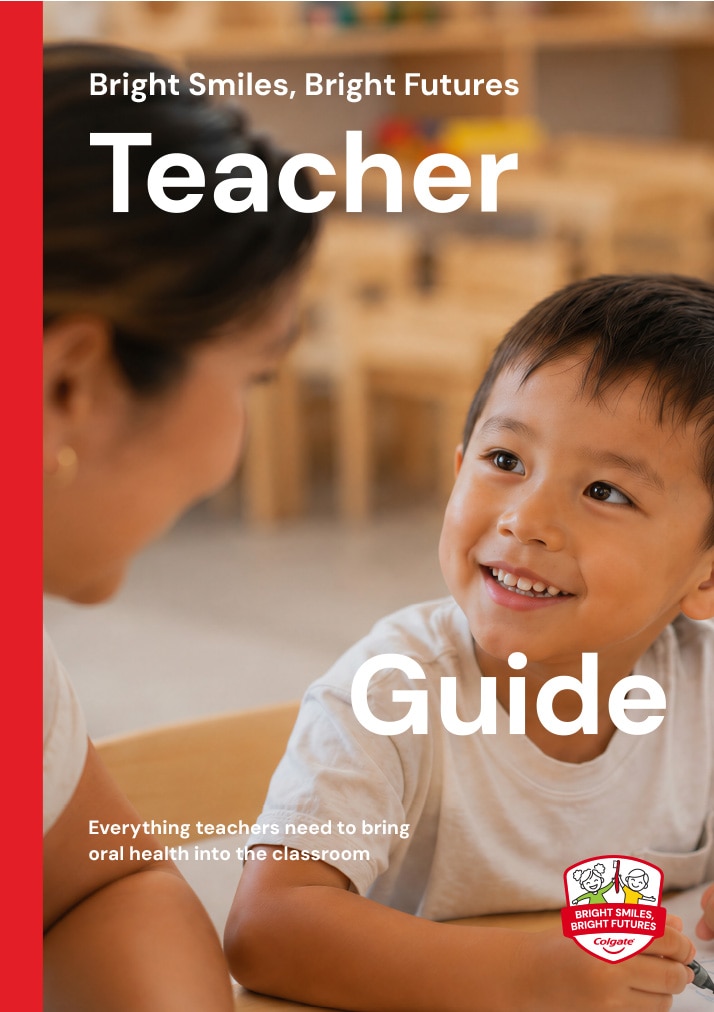 Cover of the Colgate Bright Smiles, Bright Futures Teacher Guide featuring a smiling young student in a classroom setting.
