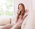 woman drinking water to aid her submandibular gland swelling
