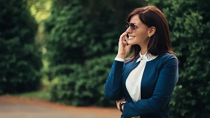 woman on phone with dentist discussing braces or aligners