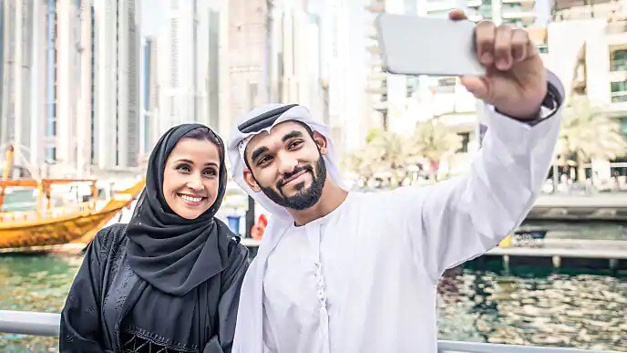 A couple taking a selfie while sightseeing in the city