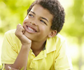 kid with braces smiling outside