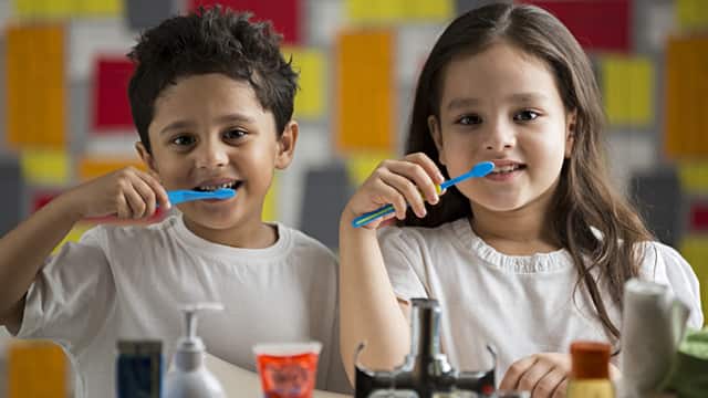Two children brushing their teeth