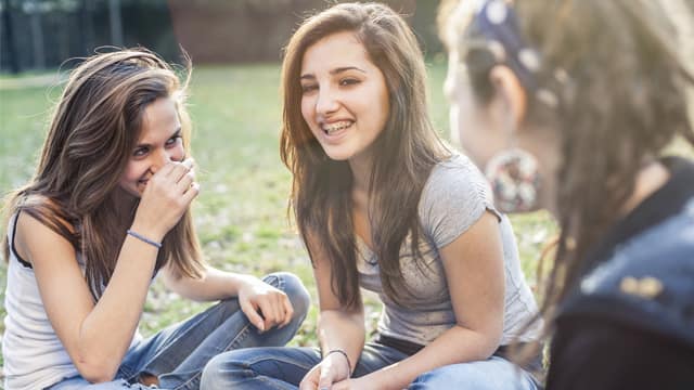 Group of affectionate teenagers in the park