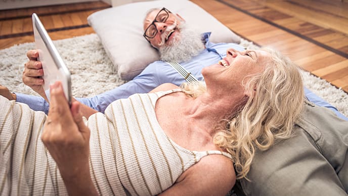 Old couple talking the benefits of using electric toothbrush