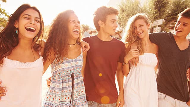 Group of teenage girls and boys outdoors