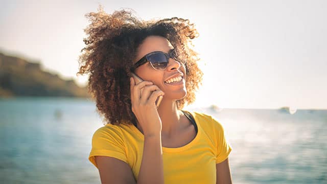 A woman is making a call outside