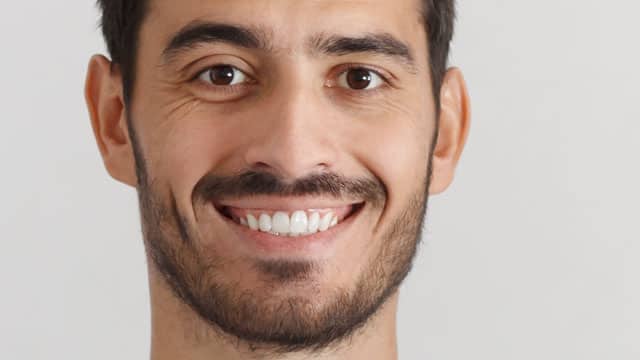 A man smiling indoors