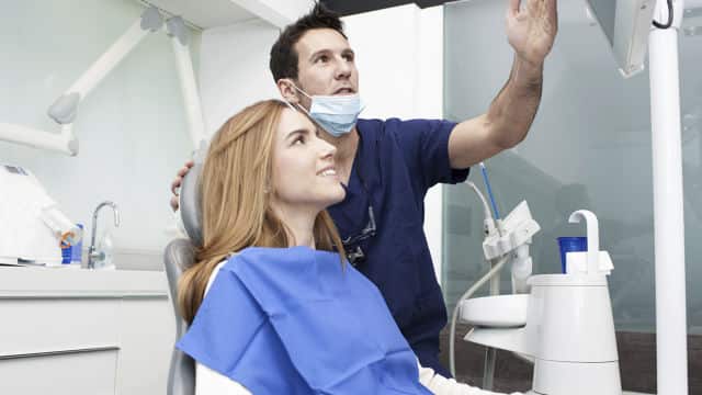 a dentist showing an x-ray to the patient
