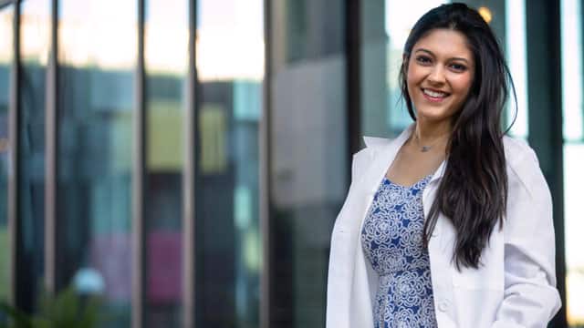 Smiling woman in a lab coat.