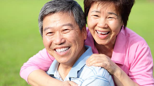elderly Asian couple smiling