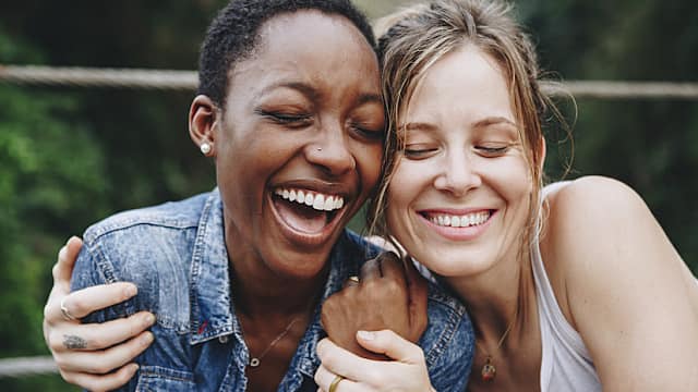 Happy friends holding each other