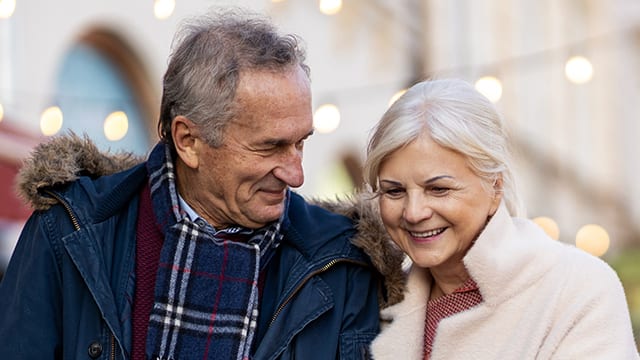 Lovingly senior couple discussing denture needs.