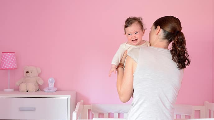 mother putting her baby to sleep