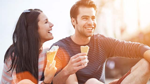 Couple eating ice cream outdoors