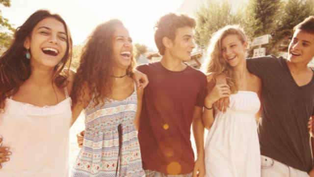 A group of friends hugging and smiling.