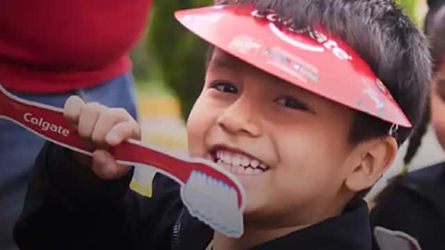 Kid smiling with a cartoon toothbrush