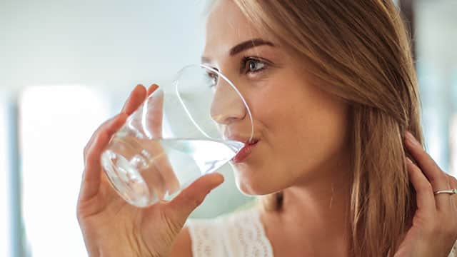 A woman is drinking water