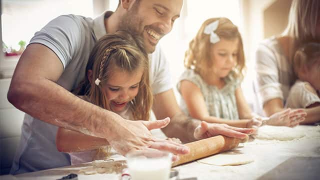 A family is making cookies in kitchen