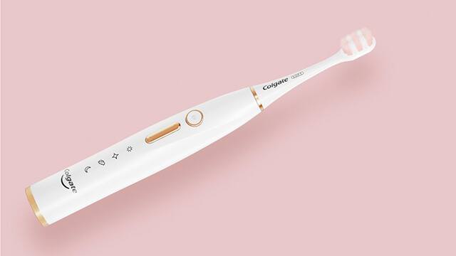 Electric toothbrush on pink background