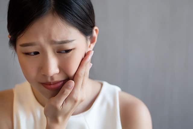 Woman having a tooth pain