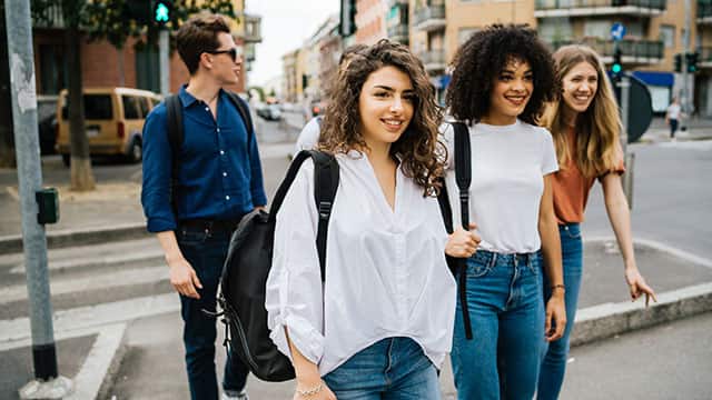 Group of friends walking down the street in the city