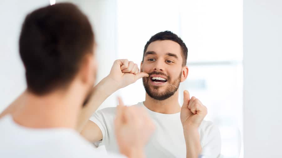 Man using dental floss