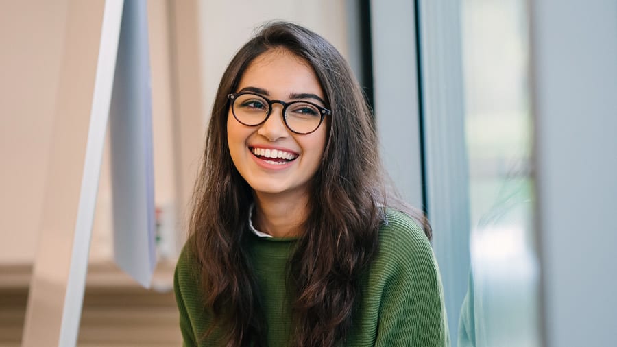 Woman with radiant smile benefiting from fluoride for strong, healthy teeth
