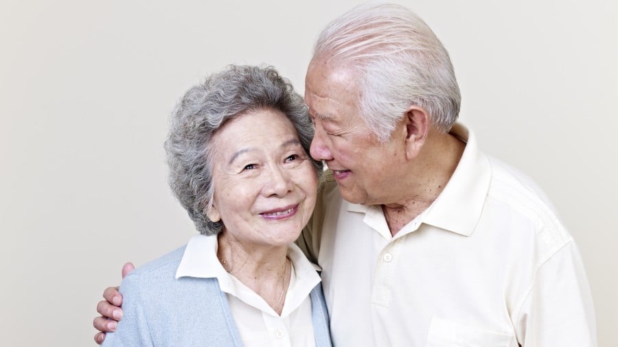 An elderly couple smiling