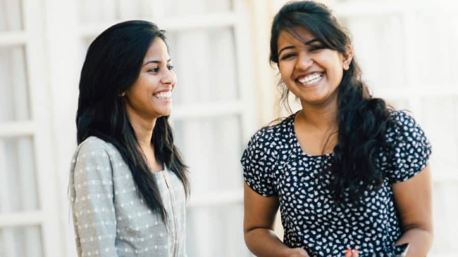 Women with confident smiles, accentuated by dental grills